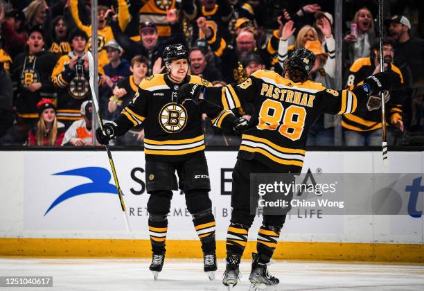 Hampus Lindholm and David Pastrnak of the Boston Bruins celebrate a first period goal against the New Jersey Devils at TD Garden on April 08, 2023 in...