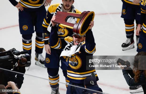 Ethan de Jong of the Quinnipiac Bobcats celebrates with the trophy after a national championship overtime win against the Minnesota Golden Gophers...