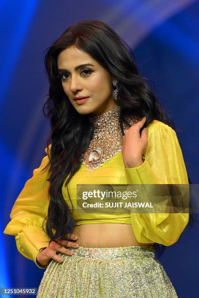 In this picture taken on April 8 Bollywood actress Amrita Rao presents a creation during the fashion show by All India Gem And Jewellery Domestic...