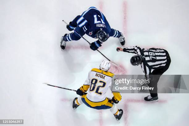 Adam Lowry of the Winnipeg Jets gets set to take a third period face-off against Tommy Novak of the Nashville Predators at the Canada Life Centre on...