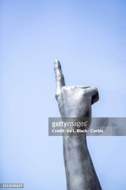 Thousands of protesters walk past Brooklyn's finger sculpture which towers over the streets at 22 1/2 feet tall. The big bronze arm sits right at the...