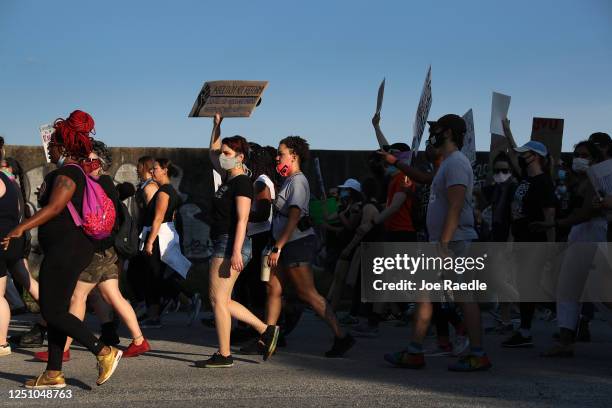 Demonstrators march through the streets against police brutality and racism on June 20, 2020 in Atlanta, Georgia. Demonstrations have been held...