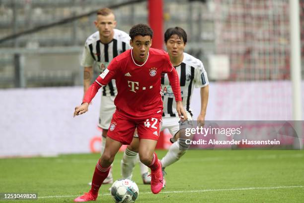 Jamal Musiala of FC Bayern Muenchen runs with the ball during the Bundesliga match between FC Bayern Muenchen and Sport-Club Freiburg at Allianz...