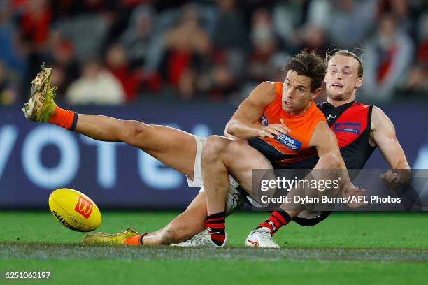 Josh Kelly of the Giants is tackled by Mason Redman of the Bombers during the 2023 AFL Round 04 match between the Essendon Bombers and the GWS Giants...