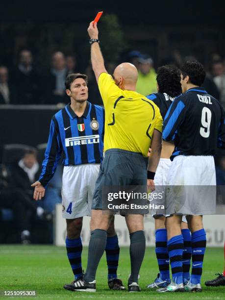 Javier Zanetti of Inter Milan protests to the referee as Nicolas Burdisso is sent off during the UEFA Champions League Round of 16 second leg match...