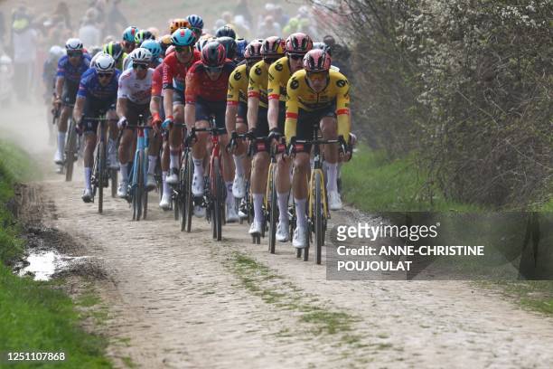 The pack of riders cycles over a cobblestone sector during the 120th edition of the Paris-Roubaix one-day classic cycling race, between Compiegne and...