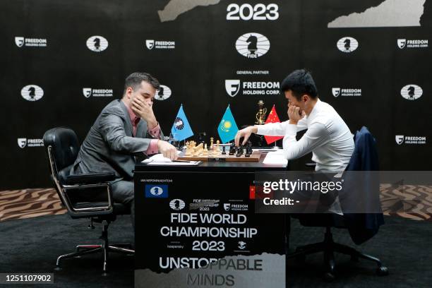 Grandmasters Ian Nepomniachtchi from Russia and Ding Liren from China attend the first game of a 14-game match to decide who will be the new 17th...