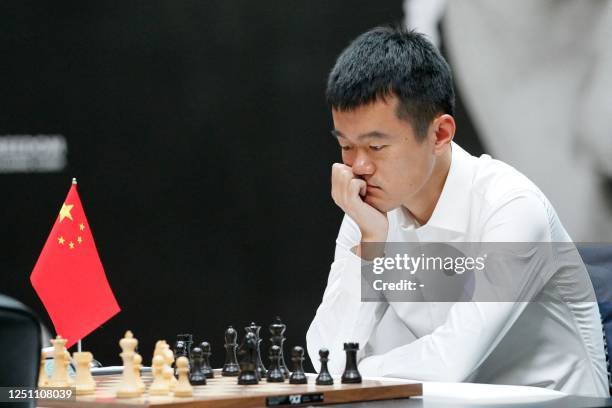 Grandmaster Ding Liren from China competes during the first game of a 14-game match to decide who will be the new 17th World Chess Champion in Astana...