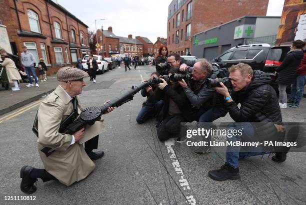 Reenactor Eddie O'Neill has his picture taken at Beechmount Avenue near the Falls Road, Belfast, before taking part in a parade organised by Sinn...