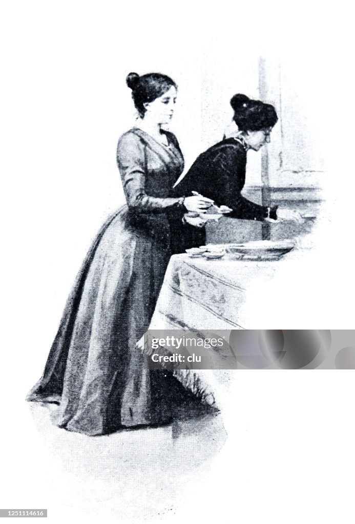 Two women set the table