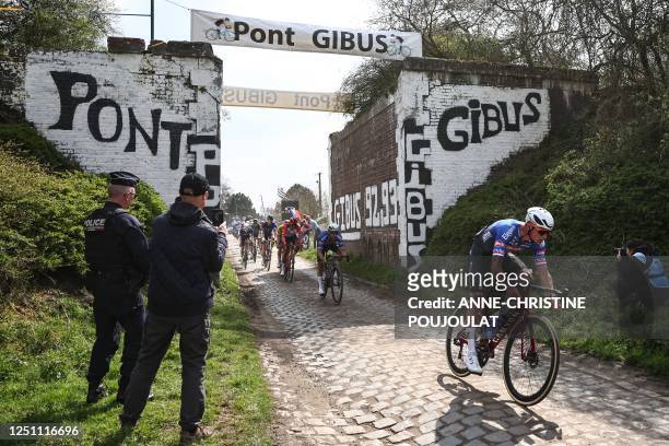 Alpecin-Deceuninck team's Dutch rider Mathieu Van Der Poel cycles over the Pont Gibus cobblestone sector during the 120th edition of the...