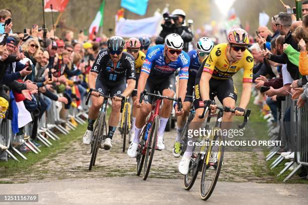 Jumbo-Visma team's Belgian rider Wout Van Aert and Alpecin-Deceuninck team's Dutch rider Mathieu Van Der Poel cycle with a pack of riders over the...