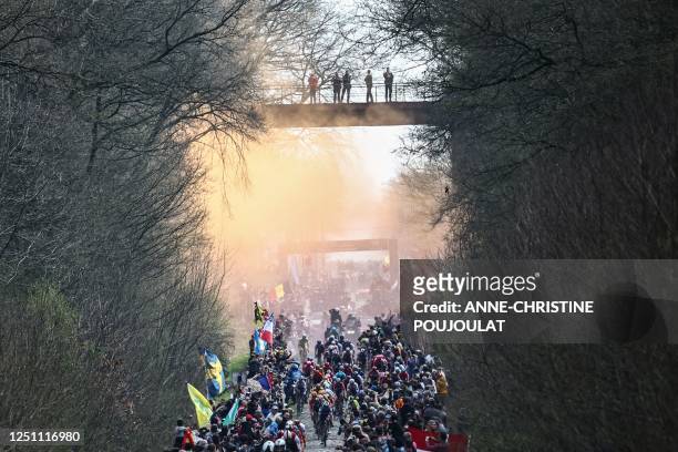 The pack of riders cycles over the Trouee d'Arenberg cobblestone sector during the 120th edition of the Paris-Roubaix one-day classic cycling race,...