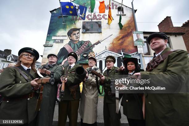 Republicans dressed in vintage themed military uniforms pose in front of a 1916 Easter Rising mural in RPG Avenue before taking part in a...