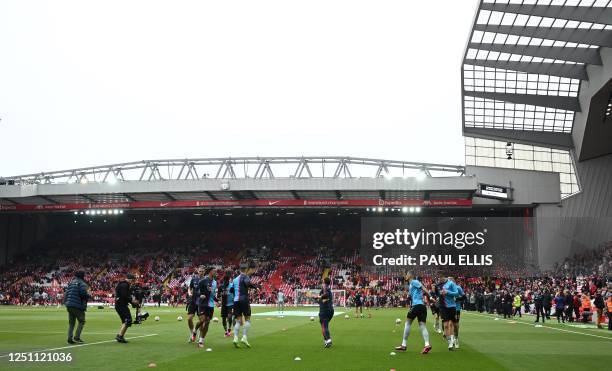 Arsenal players warms up ahead of the English Premier League football match between Liverpool and Arsenal at Anfield in Liverpool, north west England...