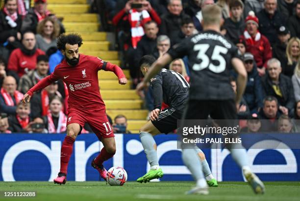 Liverpool's Egyptian striker Mohamed Salah vies with Arsenal's Brazilian midfielder Gabriel Martinelli during the English Premier League football...