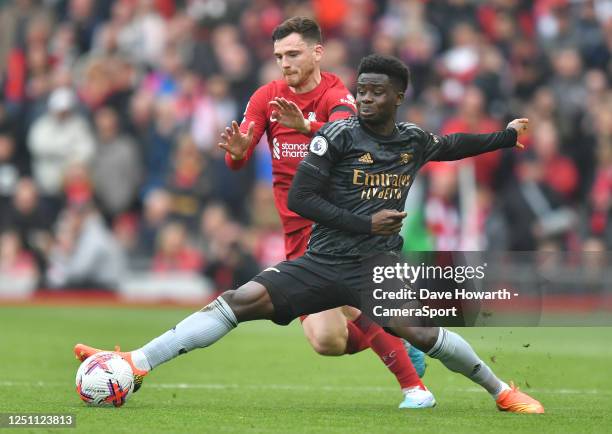 Liverpool's Andrew Robertson battles with Arsenal's Bukayo Saka during the Premier League match between Liverpool FC and Arsenal FC at Anfield on...