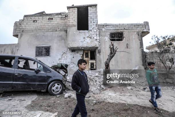 Children are seen in front of the damaged car after Bashar al-Assad regime forces attack in Sermin district of Idlib, Syria on April 09, 2023. A...