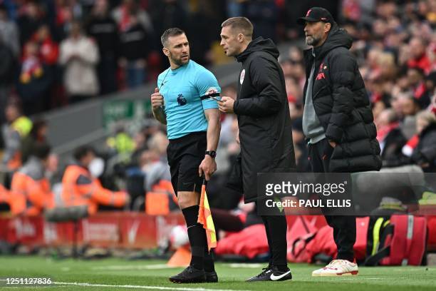 Liverpool's German manager Jurgen Klopp looks on as Fourth Official Craig Pawson talks to assistant referee and linesman Assistant Referee...