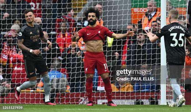 Liverpool's Egyptian striker Mohamed Salah reacts after missing a penalty during the English Premier League football match between Liverpool and...