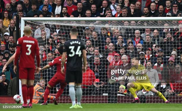 Arsenal's English goalkeeper Aaron Ramsdale watvhes the ball go wide of the gol as Liverpool's Egyptian striker Mohamed Salah misses a penalty during...