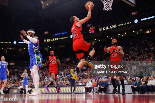 Malachi Flynn of the Toronto Raptors drives to the net past Wesley Matthews of the Milwaukee Bucks during the first half of their NBA game at...