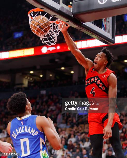 Scottie Barnes of the Toronto Raptors dunks against MarJon Beauchamp of the Milwaukee Bucks during the first half of their NBA game at Scotiabank...