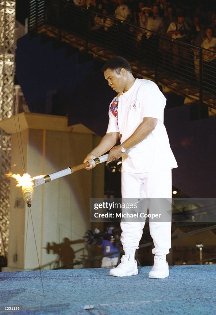 19 Jul 1996: Muhammad Ali holds the torch before lighting the Olympic Flame during the Opening Cere