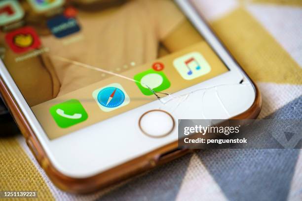 broken iphone 7 developed by the company apple inc. - cracked iphone stock pictures, royalty-free photos & images