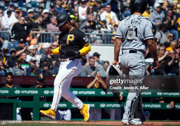 Canaan Smith-Njigba of the Pittsburgh Pirates scores on a sacrifice fly in the second inning against the Chicago White Sox during inter-league play...