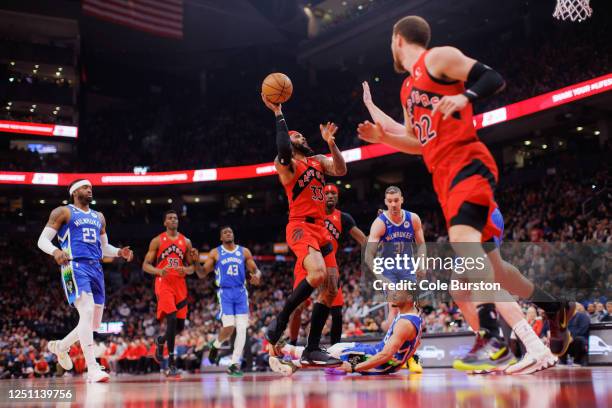 Gary Trent Jr. #33 of the Toronto Raptors drives to the net against Lindell Wigginton of the Milwaukee Bucks during the first half of their NBA game...