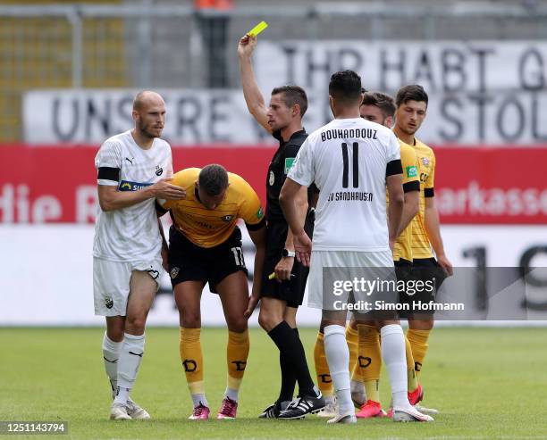 Gerrit Nauber of SV Sandhausen is shown a yellow card by Referee Robert Kempter after a foul on Rene Klingenburg of SG Dynamo Dresden during the...