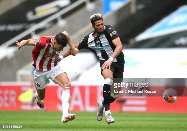 John Egan of Sheffield United pulls the shirt of Joelinton of Newcastle United which leads to the second yellow card for John Egan and him being sent...