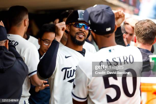 Byron Buxton of the Minnesota Twins celebrates scoring a run with teammate Willi Castro off an RBI double by teammate Donovan Solano in the fourth...