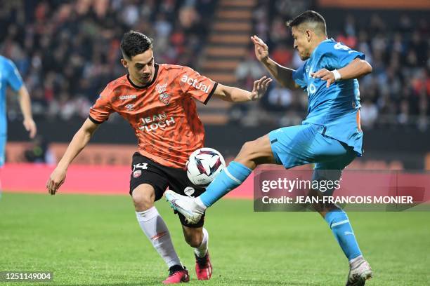 Lorient's French midfielder Romain Faivre fights for the ball with Marseille's Chilean forward Alexis Sanchez during the French L1 football match...