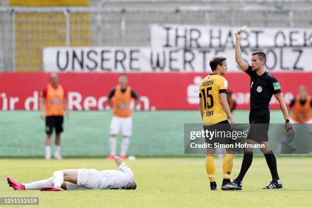 Chris Loewe of SG Dynamo Dresden is shown a red card by Referee Robert Kempter after a foul on Enrique Pena Zauner of SV Sandhausen during the Second...