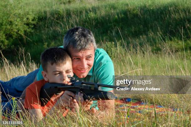 father and son rifle lessons - air rifle shooting stock pictures, royalty-free photos & images