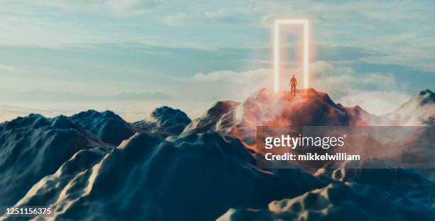 man stands in front of glowing portal and is about to enter the unknown - spirituality stock pictures, royalty-free photos & images