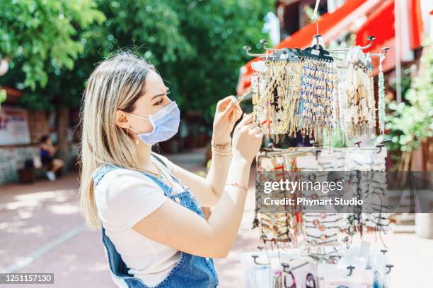 women enjoy shopping for jewelry at city street - pop up store stock pictures, royalty-free photos & images