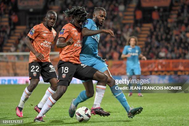 Lorient's Ivorian defender Bamo Meite fights for the ball with Marseille's Portuguese defender Nuno Tavares during the French L1 football match...
