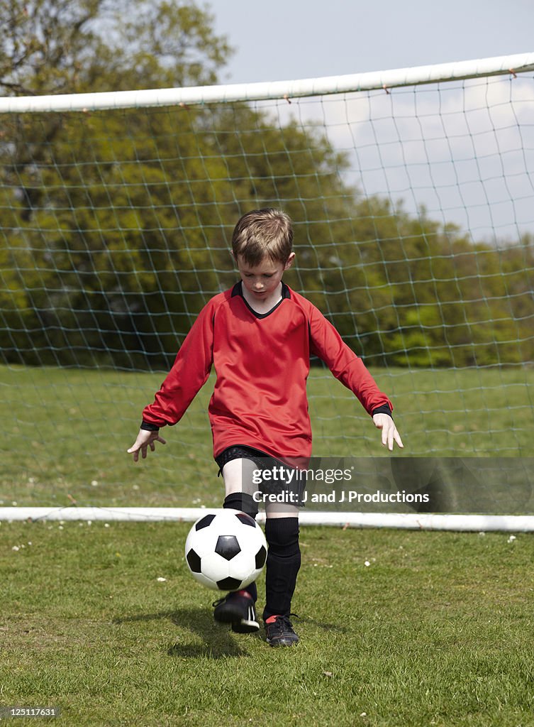 Boy balancing a football