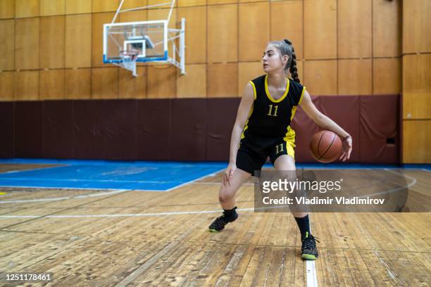 dribbling a ball - women's basketball stock pictures, royalty-free photos & images