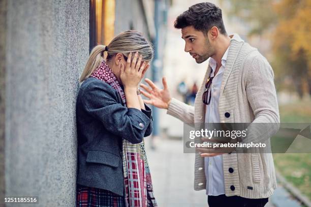 couple is arguing on the street - partner violence stock pictures, royalty-free photos & images