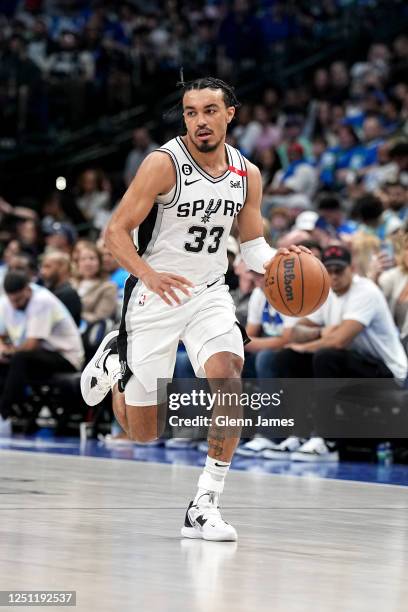 Tre Jones of the San Antonio Spurs moves the ball during the game against the Dallas Mavericks on April 9, 2023 at the American Airlines Center in...