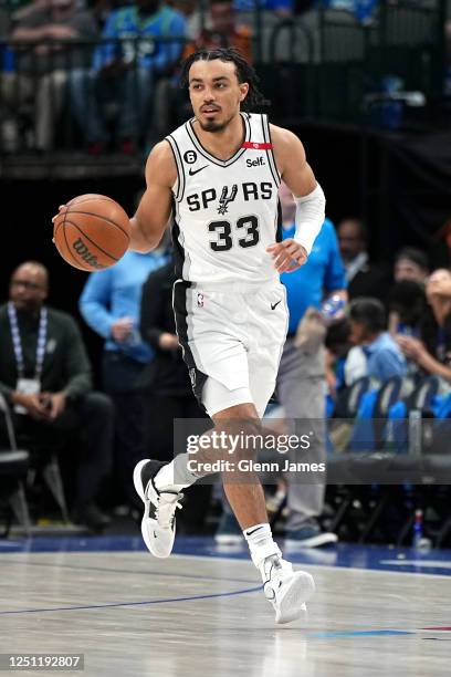 Tre Jones of the San Antonio Spurs moves the ball during the game against the Dallas Mavericks on April 9, 2023 at the American Airlines Center in...