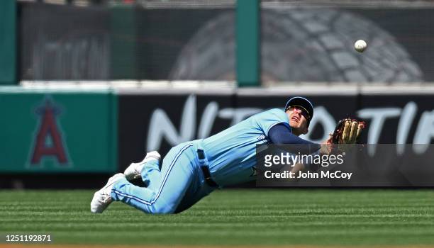 Daulton Varsho of the Toronto Blue Jays lost a ball in the sun hit by Anthony Rendon of the Los Angeles Angels in the first inning at Angel Stadium...
