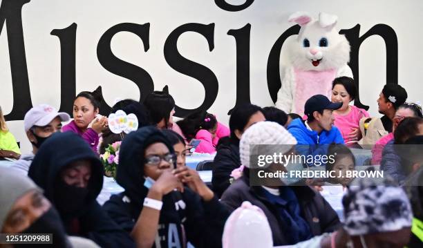 Costumed Easter Bunny meets and greets people waiting for their meal at the Los Angeles Mission during the annual Easter Celebration for the homeless...