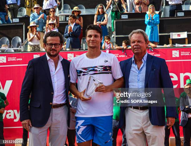 Miomir Kecmanovic of Serbia holds a trophy after the Final of the Millennium Estoril Open tournament against Casper Ruud of Norway at CTE- Clube de...