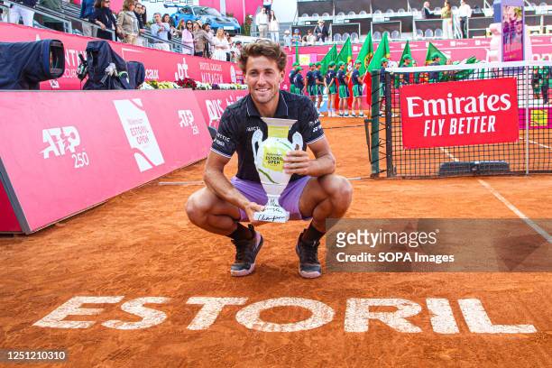 Casper Ruud of Norway poses for a photo while holding a trophy after the Final of the Millennium Estoril Open tournament against Miomir Kecmanovic of...