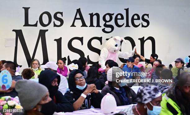 Costumed Easter Bunny meets and greets people waiting for their meal at the Los Angeles Mission during the annual Easter Celebration for the homeless...